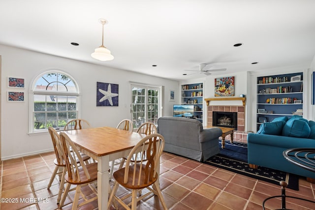 404 5th Ave, Spring Lake, NJ 07762 - tiled dining area with ceiling fan, a tiled fireplace, and built in features
