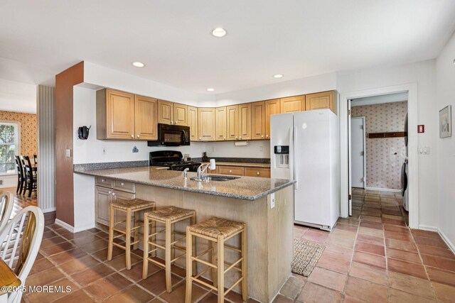 404 5th Ave, Spring Lake, NJ 07762 - kitchen with black appliances, a kitchen breakfast bar, stone countertops, recessed lighting, and light tile patterned flooring
