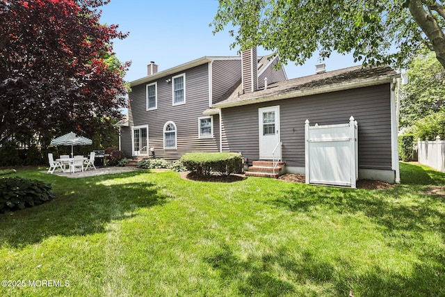 404 5th Ave, Spring Lake, NJ 07762 - rear view of house with entry steps, a chimney, and a patio area