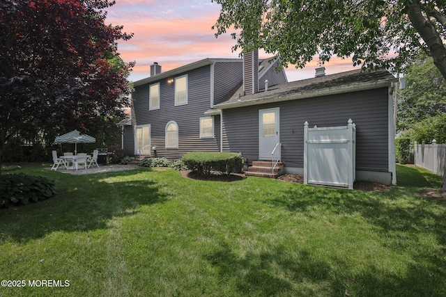 404 5th Ave, Spring Lake, NJ 07762 - back of property at dusk with entry steps, a chimney, and a patio area