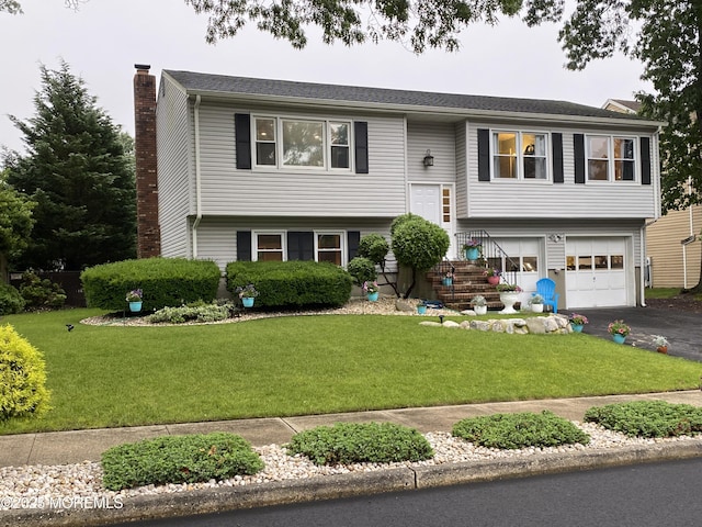 3 Maria Ct, Brick, NJ 08724 - raised ranch with a chimney, driveway, a garage, and a front yard