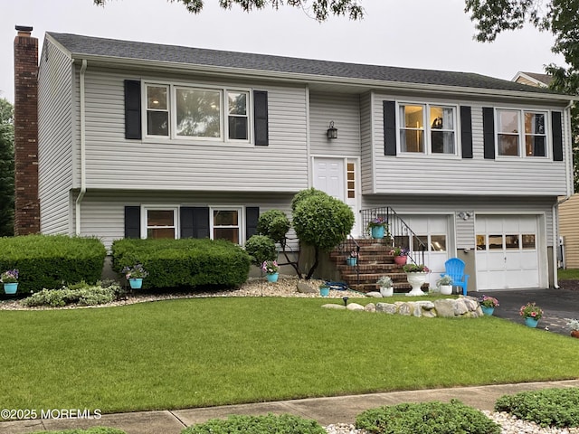 3 Maria Ct, Brick, NJ 08724 - split foyer home with an attached garage, a front yard, driveway, and a chimney