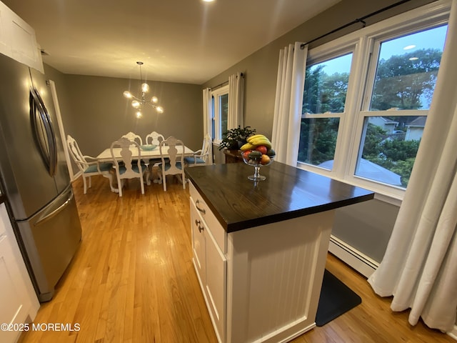 3 Maria Ct, Brick, NJ 08724 - kitchen with freestanding refrigerator, a baseboard heating unit, butcher block countertops, white cabinets, and light wood-type flooring