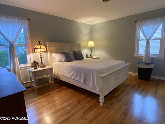 3 Maria Ct, Brick, NJ 08724 - bedroom featuring wood finished floors and a baseboard heating unit