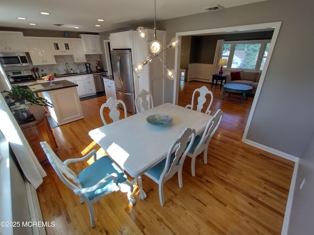 3 Maria Ct, Brick, NJ 08724 - dining room with light wood-style floors and a baseboard heating unit
