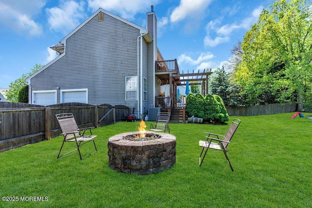 41 Hampshire Blvd, Jackson, NJ 08527 - back of house with a chimney, an outdoor fire pit, a fenced backyard, and a wooden deck