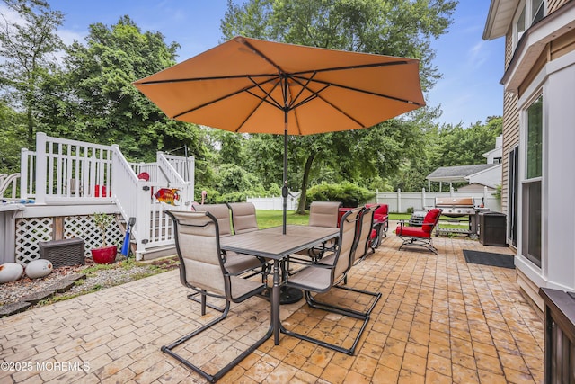 39 Sweet Gum Rd, Howell, NJ 07731 - fenced backyard featuring outdoor dining area, a patio area, view of scattered trees, stairs, and a wooden deck