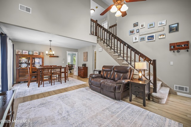 39 Sweet Gum Rd, Howell, NJ 07731 - living room with wood finished floors, stairs, ceiling fan, high vaulted ceiling, and a chandelier