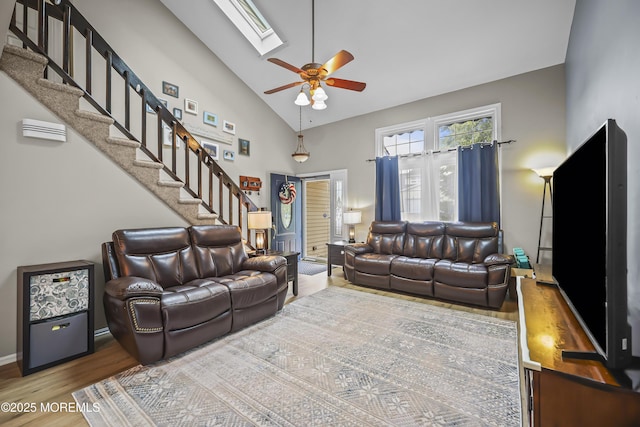 39 Sweet Gum Rd, Howell, NJ 07731 - living room featuring wood finished floors, ceiling fan, high vaulted ceiling, stairs, and a skylight