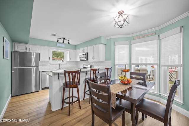 39 Sweet Gum Rd, Howell, NJ 07731 - dining area featuring light wood-style flooring and crown molding