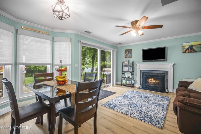 39 Sweet Gum Rd, Howell, NJ 07731 - dining area featuring ornamental molding, ceiling fan, a fireplace, and wood finished floors