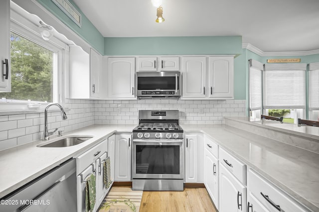 39 Sweet Gum Rd, Howell, NJ 07731 - kitchen with stainless steel appliances, white cabinets, backsplash, and light wood-style flooring