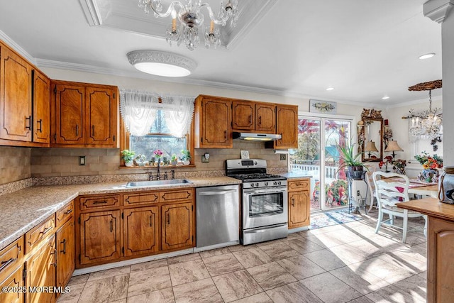 426 Shady Ln, Howell, NJ 07731 - kitchen with appliances with stainless steel finishes, a chandelier, healthy amount of natural light, brown cabinetry, and ornamental molding