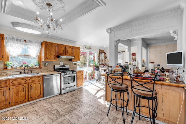 426 Shady Ln, Howell, NJ 07731 - kitchen with stainless steel appliances, under cabinet range hood, ornamental molding, light countertops, and decorative backsplash