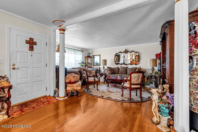426 Shady Ln, Howell, NJ 07731 - living area with decorative columns, wood-type flooring, and ornamental molding