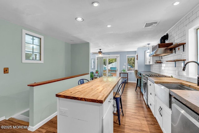 276 Chandler Rd, Jackson, NJ 08527 - kitchen featuring appliances with stainless steel finishes, butcher block countertops, a breakfast bar, white cabinets, and dark wood finished floors