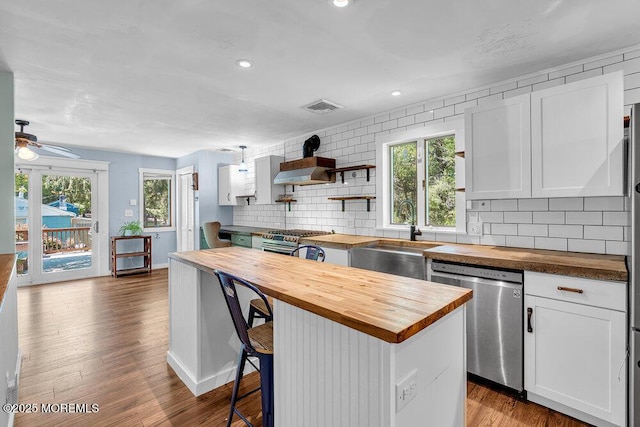 276 Chandler Rd, Jackson, NJ 08527 - kitchen featuring wood counters, stainless steel appliances, a center island, backsplash, and ceiling fan