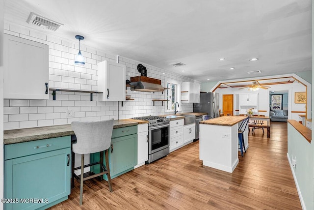 276 Chandler Rd, Jackson, NJ 08527 - kitchen with wood counters, open shelves, stainless steel appliances, backsplash, and white cabinetry