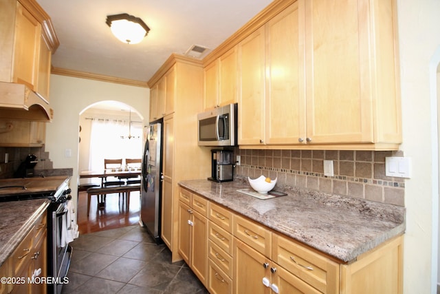 20 Atlantis Ter, Freehold, NJ 07728 - kitchen featuring stainless steel appliances, arched walkways, decorative backsplash, crown molding, and dark tile patterned flooring