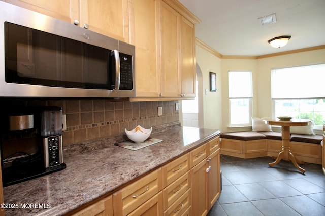 20 Atlantis Ter, Freehold, NJ 07728 - kitchen featuring stainless steel microwave, backsplash, ornamental molding, light stone countertops, and tile patterned flooring