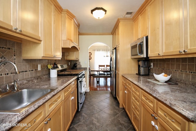 20 Atlantis Ter, Freehold, NJ 07728 - kitchen with appliances with stainless steel finishes, arched walkways, decorative backsplash, crown molding, and dark tile patterned flooring