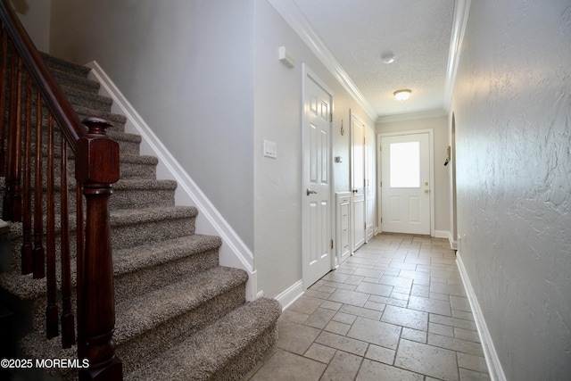 20 Atlantis Ter, Freehold, NJ 07728 - foyer entrance featuring ornamental molding, stone tile floors, stairway, and a textured ceiling