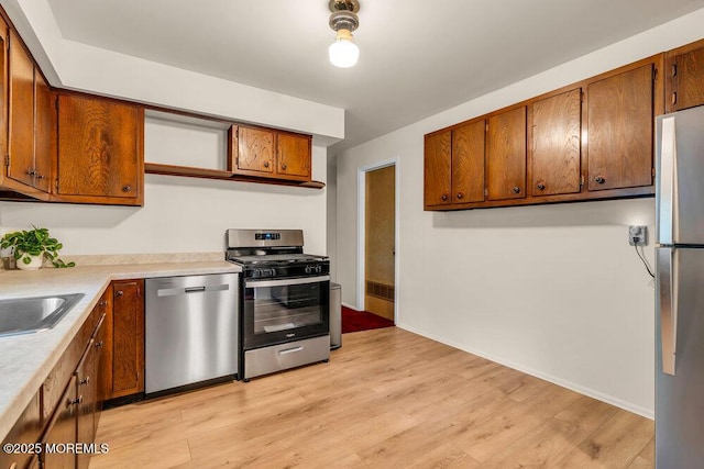 458 Drum Point Rd, Brick, NJ 08723 - kitchen featuring stainless steel appliances, light wood-style floors, light countertops, and brown cabinets