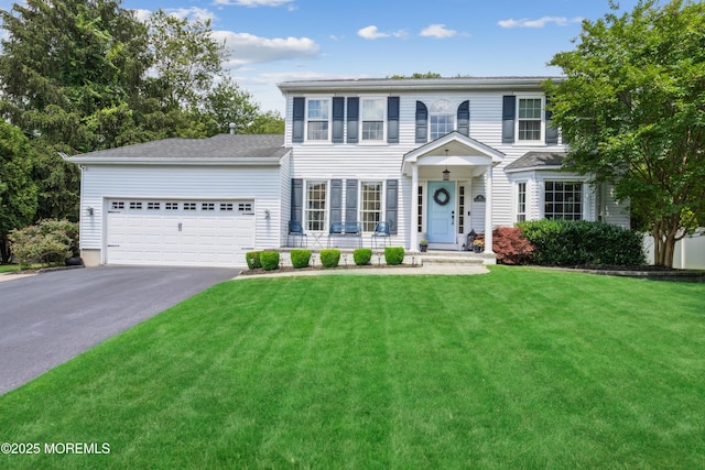 43 Sweet Gum Rd, Howell, NJ 07731 - colonial-style house featuring asphalt driveway, a front yard, and an attached garage