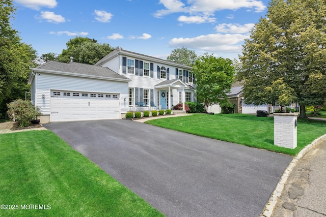 43 Sweet Gum Rd, Howell, NJ 07731 - colonial-style house with driveway, a garage, and a front lawn