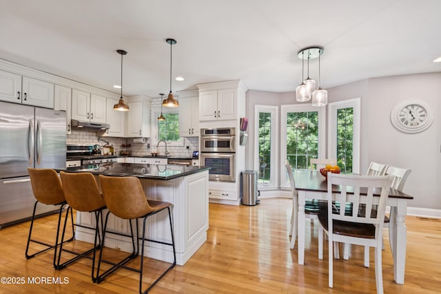 43 Sweet Gum Rd, Howell, NJ 07731 - kitchen featuring stainless steel appliances, under cabinet range hood, white cabinetry, plenty of natural light, and recessed lighting