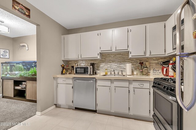 1106 Lilly Ln, Jackson, NJ 08527 - kitchen with appliances with stainless steel finishes, light countertops, and white cabinetry