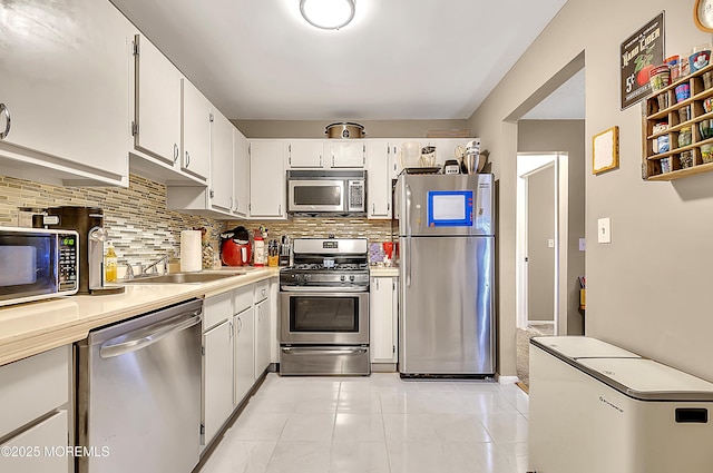 1106 Lilly Ln, Jackson, NJ 08527 - kitchen with stainless steel appliances, tasteful backsplash, light countertops, and white cabinetry