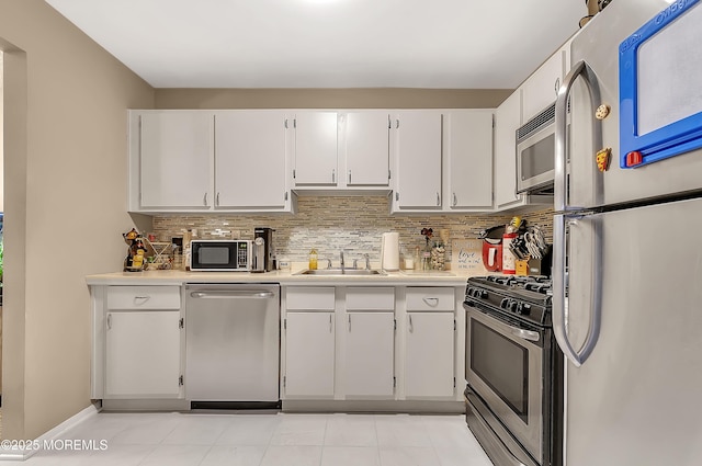 1106 Lilly Ln, Jackson, NJ 08527 - kitchen featuring stainless steel appliances, light countertops, white cabinetry, and tasteful backsplash