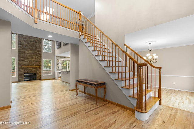 3 Canterbury Ct, Jackson, NJ 08527 - staircase with a high ceiling, wood finished floors, a chandelier, a stone fireplace, and ornamental molding
