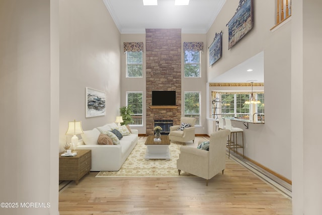 3 Canterbury Ct, Jackson, NJ 08527 - living room featuring a high ceiling, wood finished floors, a stone fireplace, crown molding, and a chandelier