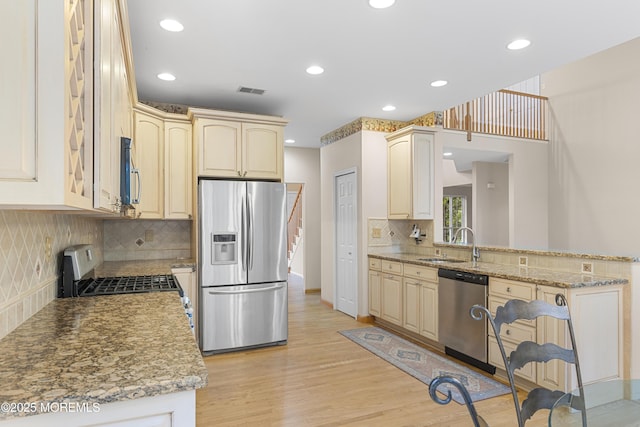 3 Canterbury Ct, Jackson, NJ 08527 - kitchen with stainless steel appliances, light wood-style floors, tasteful backsplash, light stone countertops, and recessed lighting