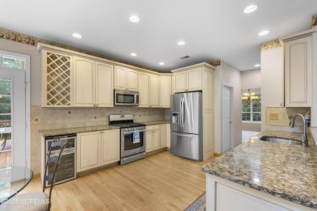 3 Canterbury Ct, Jackson, NJ 08527 - kitchen with appliances with stainless steel finishes, wine cooler, cream cabinetry, a chandelier, and backsplash