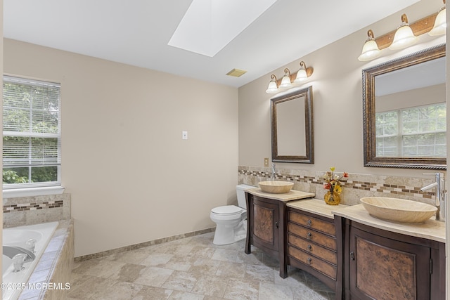 3 Canterbury Ct, Jackson, NJ 08527 - full bath with double vanity, a skylight, a garden tub, and decorative backsplash