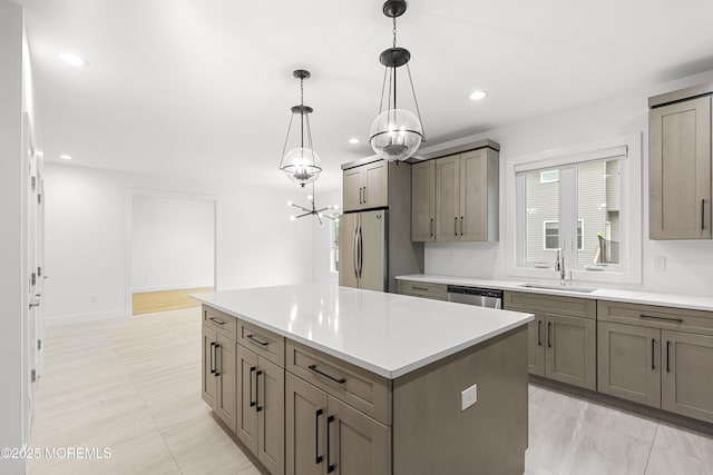 92 Wadsworth Ave, Lakewood, NJ 08701 - kitchen with stainless steel appliances, a center island, a chandelier, decorative light fixtures, and light countertops