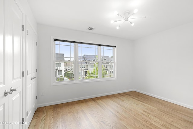 92 Wadsworth Ave, Lakewood, NJ 08701 - unfurnished bedroom with a chandelier and light wood-type flooring