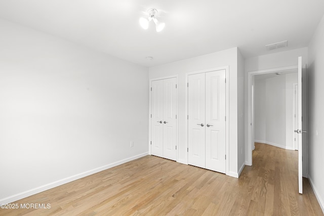 92 Wadsworth Ave, Lakewood, NJ 08701 - unfurnished bedroom featuring light wood-style floors and two closets