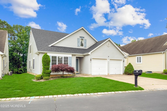 23 Dexter Ln, Jackson, NJ 08527 - traditional home with concrete driveway, an attached garage, a front yard, and a shingled roof