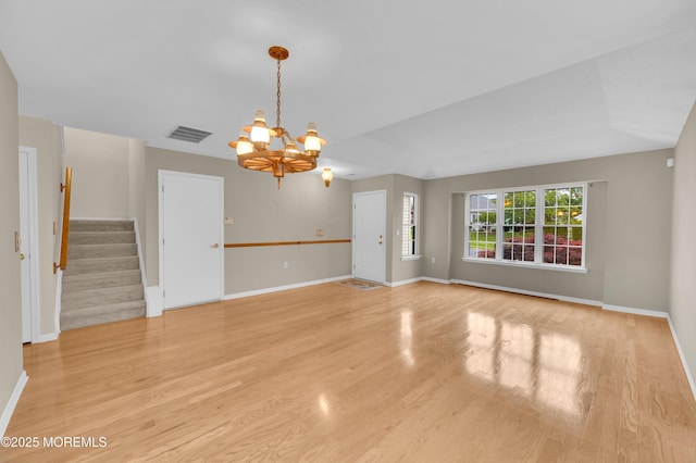 23 Dexter Ln, Jackson, NJ 08527 - unfurnished living room with a chandelier, stairway, and light wood-style floors