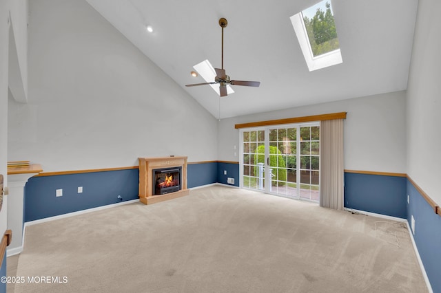 23 Dexter Ln, Jackson, NJ 08527 - unfurnished living room featuring carpet, a skylight, high vaulted ceiling, a glass covered fireplace, and ceiling fan