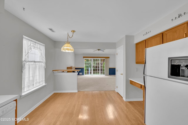 23 Dexter Ln, Jackson, NJ 08527 - kitchen with white appliances, light wood-type flooring, ceiling fan, brown cabinetry, and decorative light fixtures