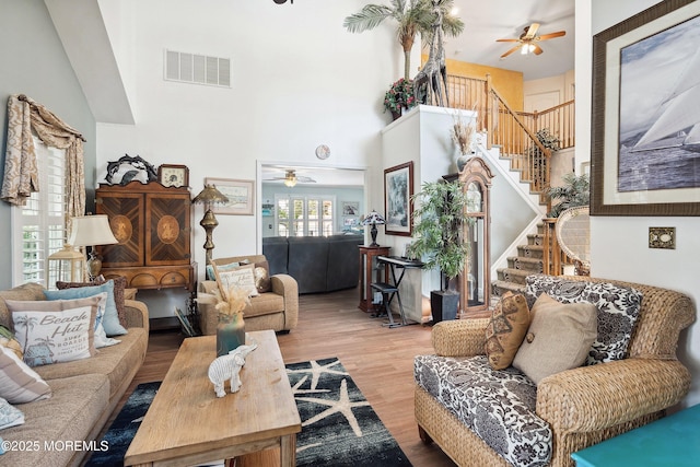648 Point Ave, Brick, NJ 08724 - living room with ceiling fan, stairs, wood finished floors, and a towering ceiling