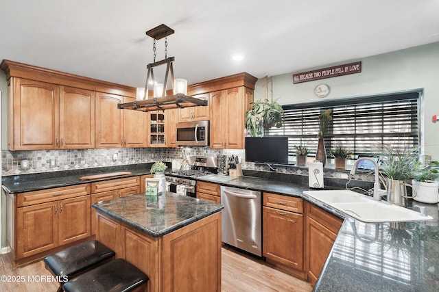 648 Point Ave, Brick, NJ 08724 - kitchen featuring stainless steel appliances, light wood-style floors, decorative backsplash, and hanging light fixtures