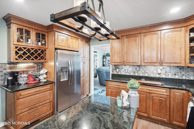 648 Point Ave, Brick, NJ 08724 - kitchen with stainless steel refrigerator with ice dispenser, tasteful backsplash, glass insert cabinets, and dark stone countertops