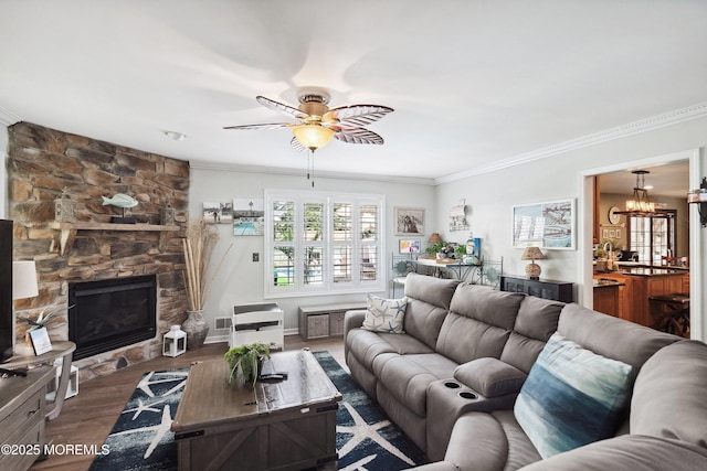 648 Point Ave, Brick, NJ 08724 - living room featuring ceiling fan, ornamental molding, a chandelier, dark wood finished floors, and a fireplace