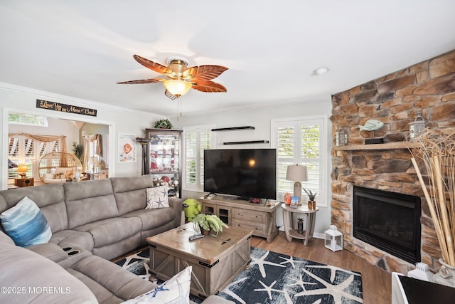 648 Point Ave, Brick, NJ 08724 - living area featuring ceiling fan, wood finished floors, crown molding, and a stone fireplace